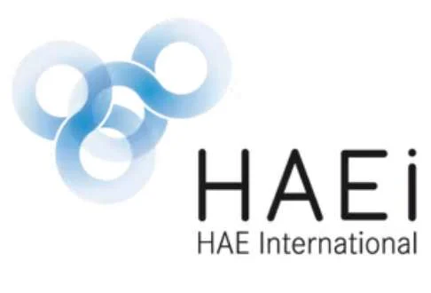 HAEi logo featuring three interconnected blue rings on the left and "HAE International" written in dark text on the right.