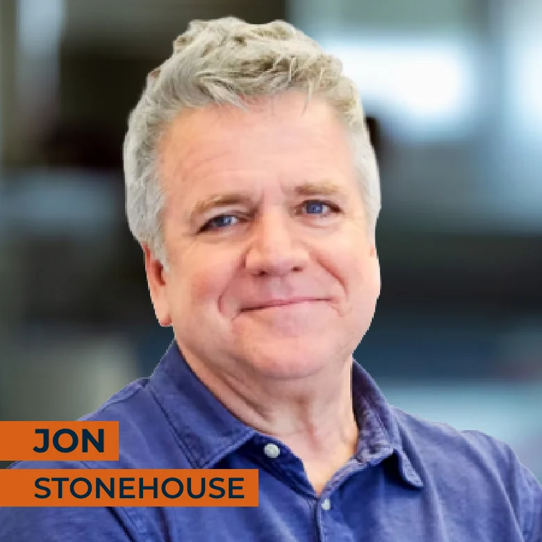 A middle-aged man with gray hair wearing a blue shirt, smiling at the camera. Text overlay reads "Jon Stonehouse.